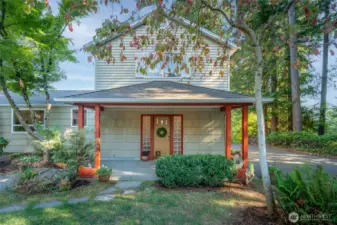 The rear entrance, tucked privately at the back, serves as the home’s main entry.