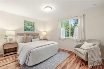 Front Bedroom downstairs is generously sized with 2 updated windows. You will love the refinished hardwood floors.