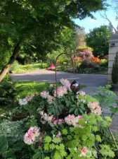 Beautiful plants and garden beds provide year-round color in this gardener’s paradise, with springtime pink rhododendrons adding extra charm.