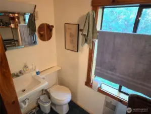 3/4 bath with shower to the left of this photo frame. Nice big wood wrapped window.