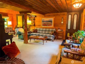 Living room from the kitchen. Door from front entry/mud room on right.