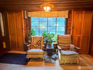 Large living room window framed by two shelving closets.