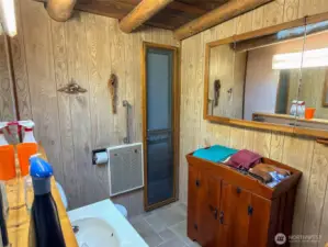 Primary bedroom full bath with a small exit door/window and 3000 watt wall heater.