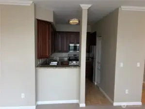 Kitchen entry view featuring warm cabinetry and efficient layout for daily living.