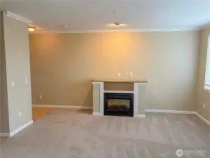 Alternate living room view highlighting fireplace detail and flexible furniture placement.