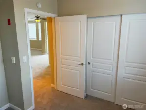 Bedroom entry with dual closets offering excellent storage solutions.