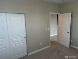 Spacious bedroom with plush carpeting and dual closets for added storage and comfort.