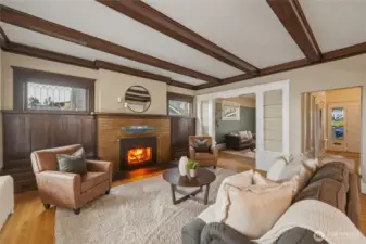 Historic craftsmanship shines with original millwork, Leaded windows, box-beam ceilings, and a warm fireplace centerpiece.