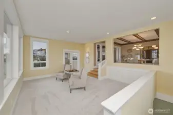 Light-filled sitting area with new carpet and picture windows capturing stunning bay views