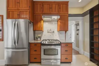 Well-appointed kitchen with granite counters, stainless appliances, and custom wood cabinetry