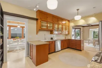 Kitchen with granite countertops, custom wood cabinets, and classic tile backsplash