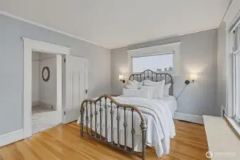 Comfortable second-floor bedroom with generous natural light and nearby bath