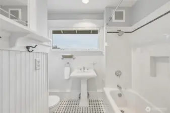 Second-level guest bath with classic subway tile, pedestal sink, and hex tile flooring