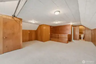 Third-level bonus room with built-in shelving and convenient half bath