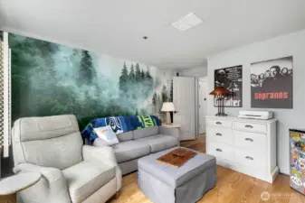 Custom northwest wall paper and room for lounging, workout, or office space.