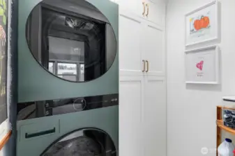 New stackable washer-and-dryer in the unit, along with convenient storage space hidden with pocket door.