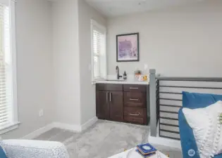 Third floor living area with a wet bar.