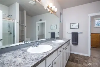 Beautifully bright, the master bathroom features double sinks, a walk-in shower, ample storage, and plenty of room to get ready for your day.