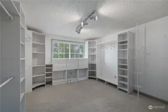 Primary suite walk in closet with amazing natural light.