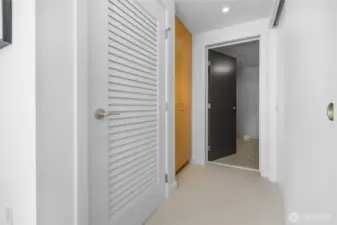 Hall way with closets to primary bathroom