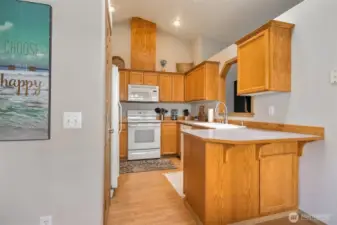The kitchen features an eating bar - perfect for 2 barstools