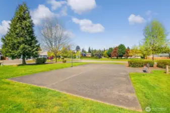 The neighborhood features a basketball court, park area and sidewalks.