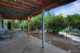 Great patio space outside of the downstairs rec room with walking paths through the garden.