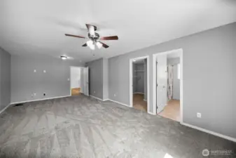 Primary Bedroom looking towards living room, walk-in closet and primary bathroom.