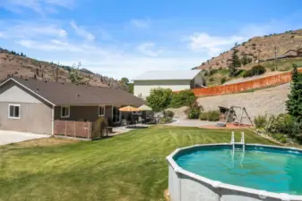 Above ground pool and back yard.
