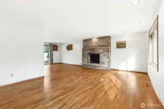This upper-level fireplace has been capped, so it is not functional. This is the open style living room and you can see that both the living and dining rooms are really nicely proportioned