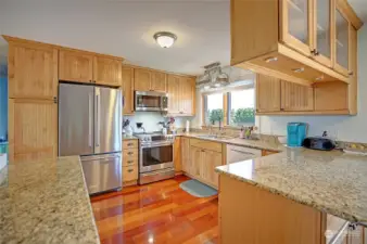 The well planned kitchen has plenty of counterspace and storage; new stove and microwave, fridge 2023, newer dishwasher. everything in easy reach.