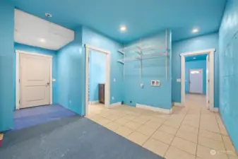 Garage access, 3rd laundry area and a bathroom with a shower.