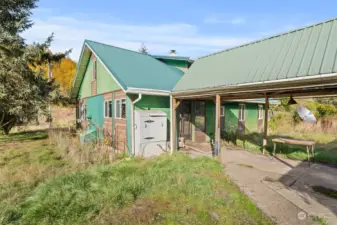 Breezeway to back of house from workshop and meat locker/freezer.