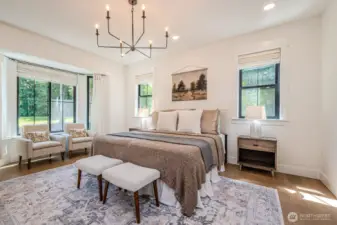 Luxurious Primary Suite with bay windows and soft, elegant finishes. Wake every morning to peaceful, serene front yard views and the quiet sounds of nature.
