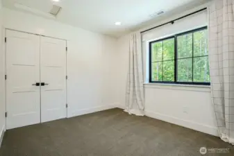 Bedroom #2 with Berber carpeting & double door closet with closet system and pretty backyard views.