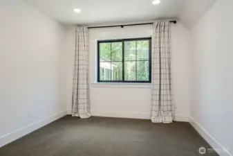 Bedroom #3 features Berber carpeting & a sizable walk-in closet with closet system and an access door to dormer storage. This room offers peaceful forest views.