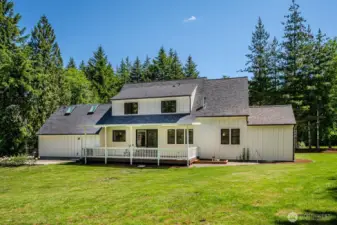 Love the expansive covered backyard deck, the sandbox on the right and additional concrete patio on the left. All of this is perfect for year-round outdoor living! Access your private trails from front and back yards!