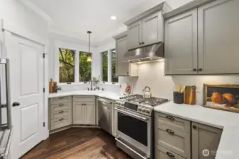Beautifully refreshed, the kitchen offers abundant prep space, stainless steel appliances, and an easy flow to the adjoining dining room and living room.  Ideal flow and space for hosting casual or formal dinners.