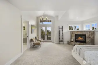 Primary bedroom with vaulted ceilings, gas fireplace, ensuite bathroom, and a very large walk out balcony complete with views.