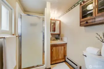 The main floor bathroom features a convenient walk-in shower for easy accessibility.