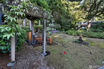 The front yard grass has a small putting green area