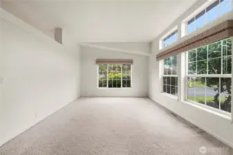 As you enter, this large formal living room greets you with lots of large windows to keep it naturally bright.