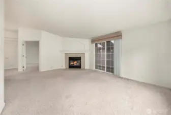 Bonus room with cozy gas fireplace is open to the kitchen.