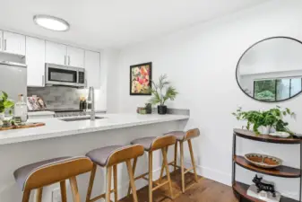 Large bar top that doubles as dining and prep space.