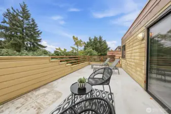 Large deck off the living room provides space for outdoor entertainment.