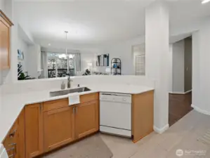 The kitchen is especially large for condominium living featuring quartz countertops, ample cabinetry, and a large pantry.