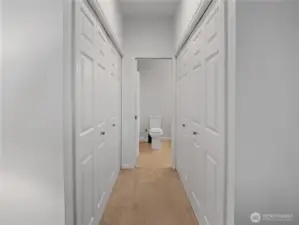 Large closets line the hallway to the bathroom. Access the bathroom from the primary bedroom or from the main hallway.