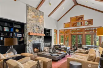 Great Room with stone fireplace and impressive beamwork