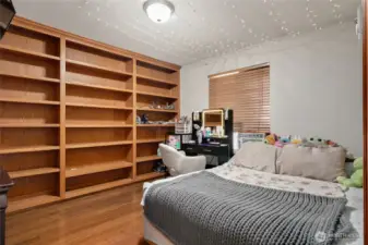 Bedroom with built-in shelving.
