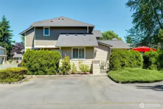 Side view of townhome with two short guest spaces.